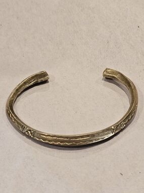 Hand-forged vintage brass cuff bracelet featuring artisan-stamped geometric